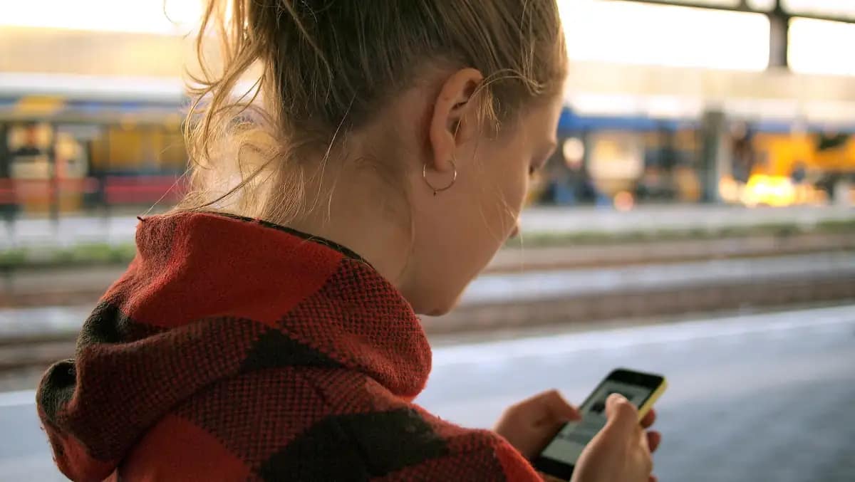 Woman posting an update on social media from her phone