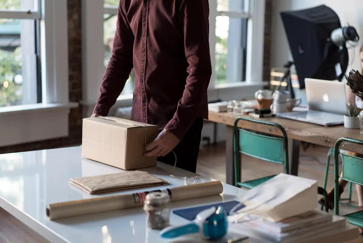 Home-based seller packing an online order to ship