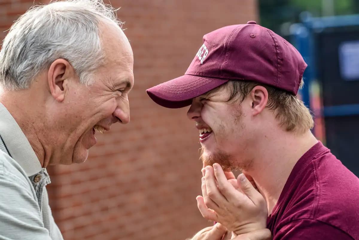 Two men sharing a laugh outside a local business