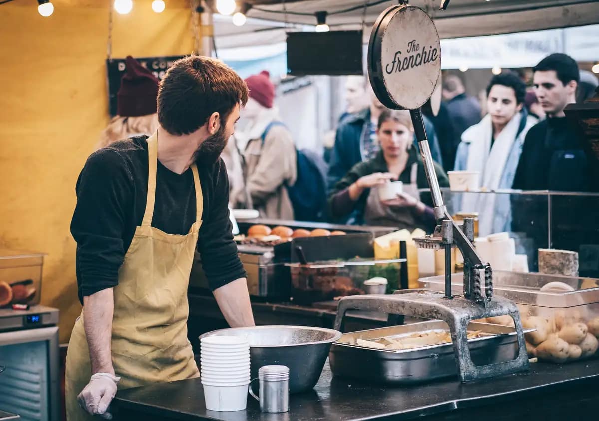 Street-food trader serving customers at his stall