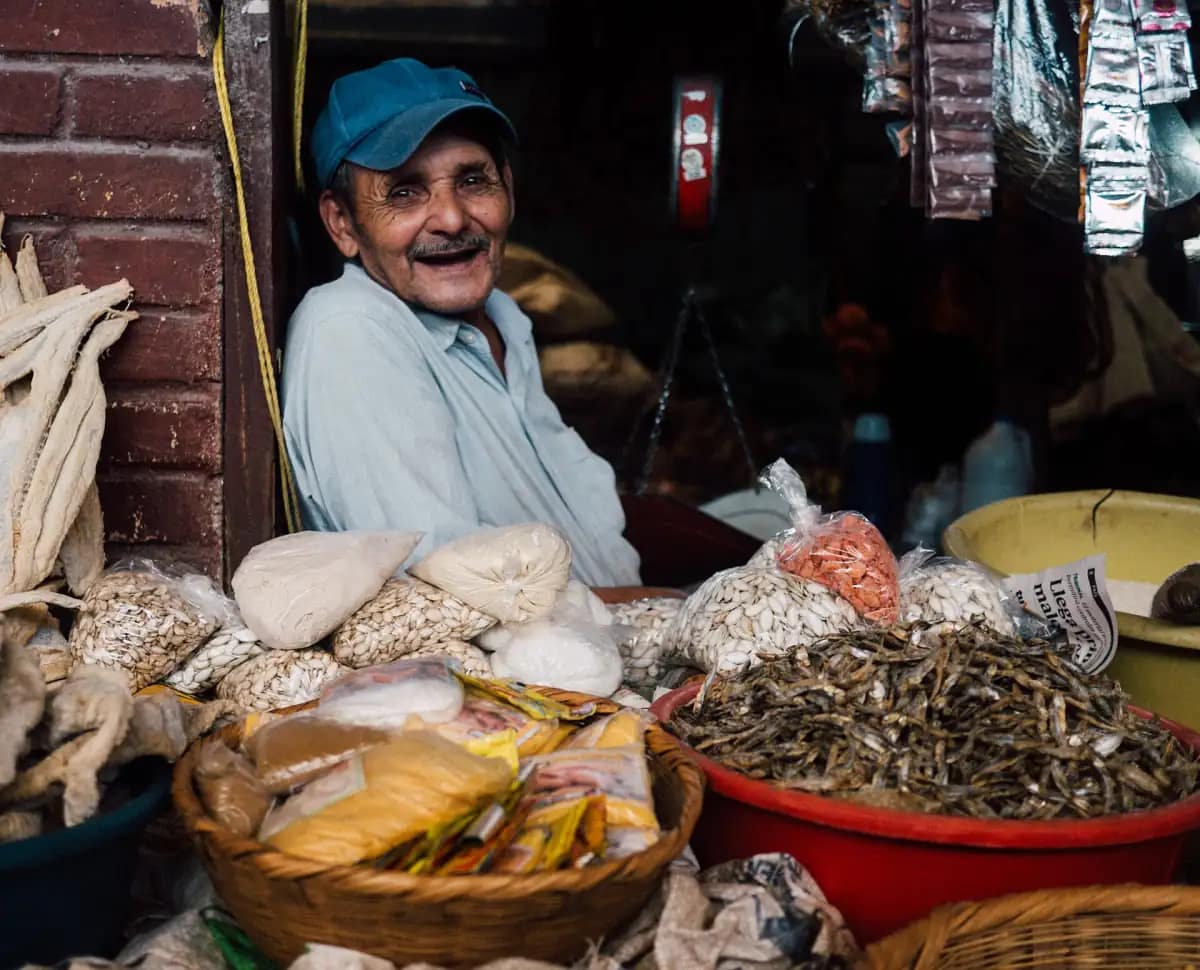 Smiling local shopkeeper in his shop