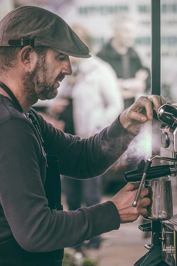 Independent coffee shop owner making coffee